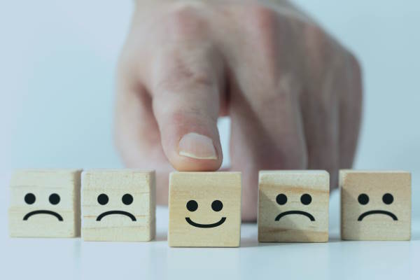 wooden cubes showing facial expressions