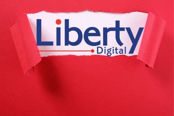 Liberty Digital Sign being revealed from behind red wrapping paper
